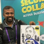 A man smiles while holding a cartoon drawing of himself as Batman at a business event booth.