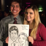 Two people smiling and holding a caricature drawing of themselves labeled "San Francisco Belle, April 7, 2016.