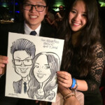 A smiling couple holds a caricature drawing of themselves at an event, dated April 7, 2016, in San Francisco.