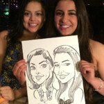 Two women smiling and holding a black-and-white caricature drawing of themselves, dated April 7, 2016, in San Francisco.